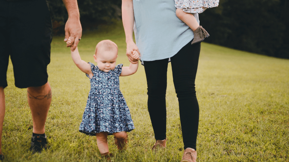 Family walking on the grass