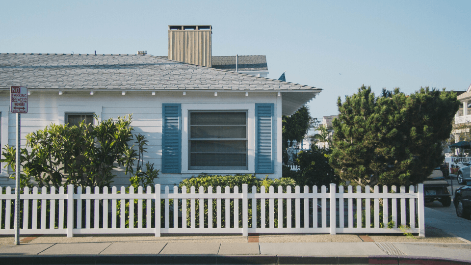 White one-story house with white fence