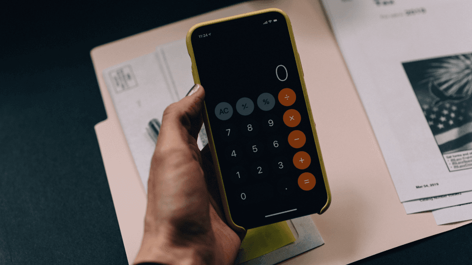 Woman holding calculator and paper folder