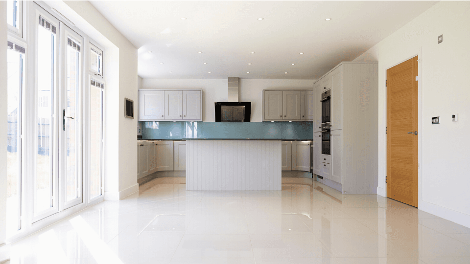 Vacant white Living Room/Kitchen with wooden door